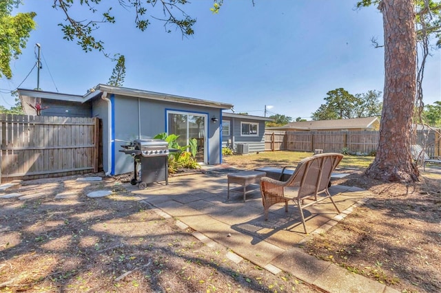 view of patio / terrace featuring central AC, a grill, and fence