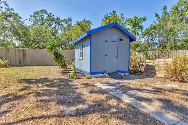 view of shed with a fenced backyard