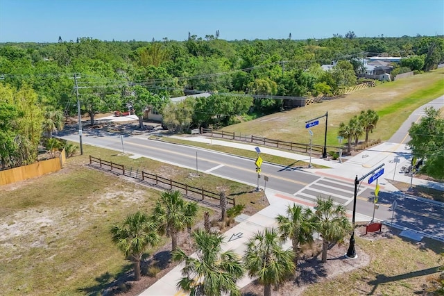 birds eye view of property featuring a wooded view