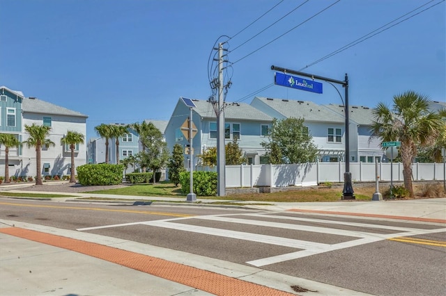 view of street with traffic signs, curbs, and sidewalks