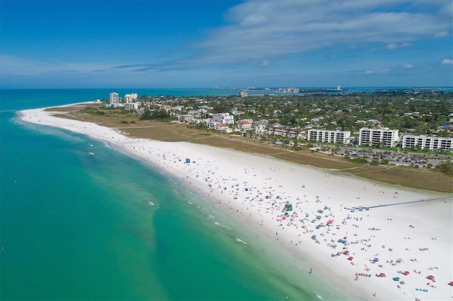 drone / aerial view featuring a beach view and a water view