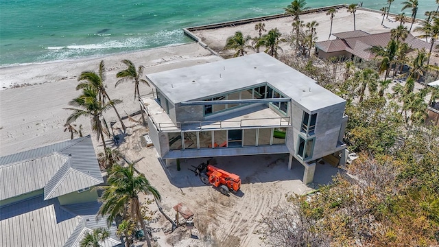 drone / aerial view with a beach view and a water view