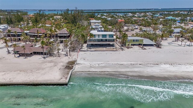 aerial view with a beach view, a water view, and a residential view