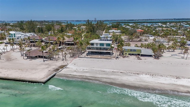 bird's eye view featuring a beach view, a water view, and a residential view