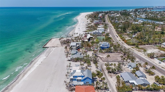 birds eye view of property featuring a view of the beach and a water view