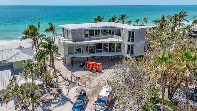 exterior space featuring a balcony and a water view
