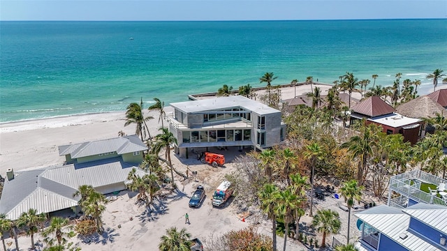 drone / aerial view with a beach view and a water view