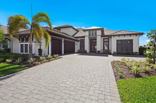 11611 Roseto Ct, Fort Myers, FL 33913 - view of front of home featuring an attached garage, decorative driveway, and stucco siding