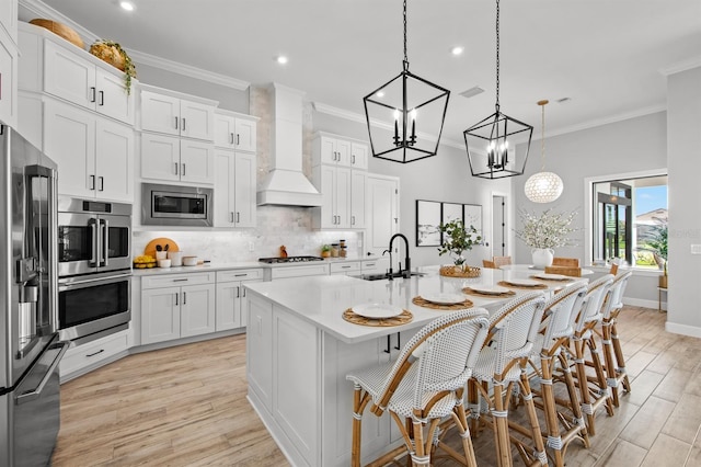 11611 Roseto Ct, Fort Myers, FL 33913 - kitchen featuring a sink, stainless steel appliances, custom range hood, recessed lighting, and crown molding