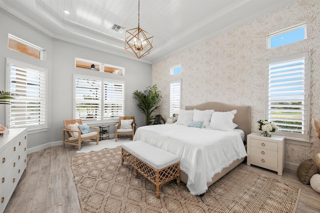11611 Roseto Ct, Fort Myers, FL 33913 - bedroom with a raised ceiling, a chandelier, wallpapered walls, light wood-style floors, and baseboards