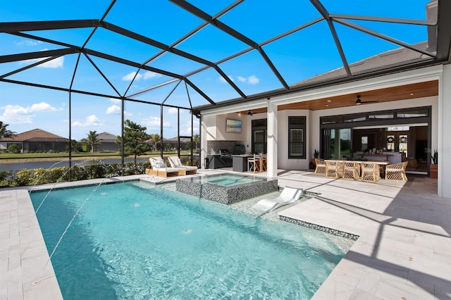 11611 Roseto Ct, Fort Myers, FL 33913 - view of swimming pool with ceiling fan, a patio, exterior kitchen, glass enclosure, and a pool with connected hot tub