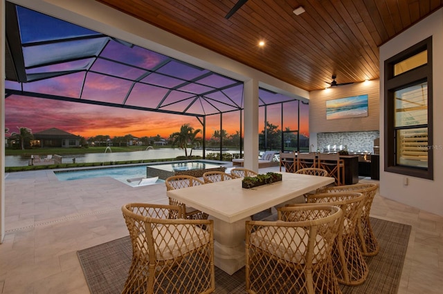 11611 Roseto Ct, Fort Myers, FL 33913 - view of patio with a pool with connected hot tub, outdoor dining area, a water view, and glass enclosure