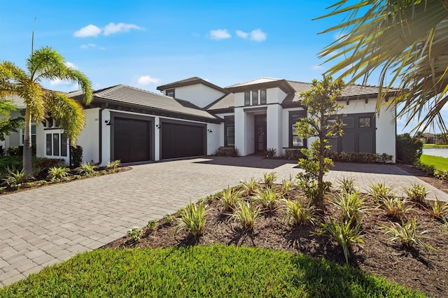 11611 Roseto Ct, Fort Myers, FL 33913 - view of front of property with stucco siding, a garage, decorative driveway, and a tiled roof