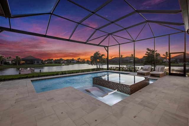 11611 Roseto Ct, Fort Myers, FL 33913 - pool at dusk with a patio area, a pool with connected hot tub, a water view, and a lanai