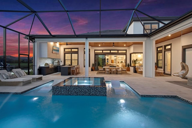 11611 Roseto Ct, Fort Myers, FL 33913 - view of swimming pool with an outdoor kitchen, a patio area, outdoor lounge area, ceiling fan, and a pool with connected hot tub