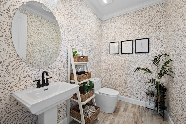 11611 Roseto Ct, Fort Myers, FL 33913 - half bathroom with wallpapered walls, ornamental molding, wood finished floors, toilet, and a sink