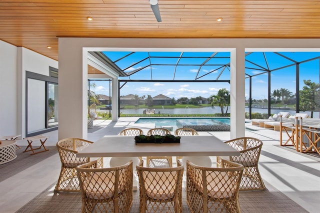 11611 Roseto Ct, Fort Myers, FL 33913 - view of patio / terrace with outdoor dining area, an outdoor pool, ceiling fan, a water view, and glass enclosure