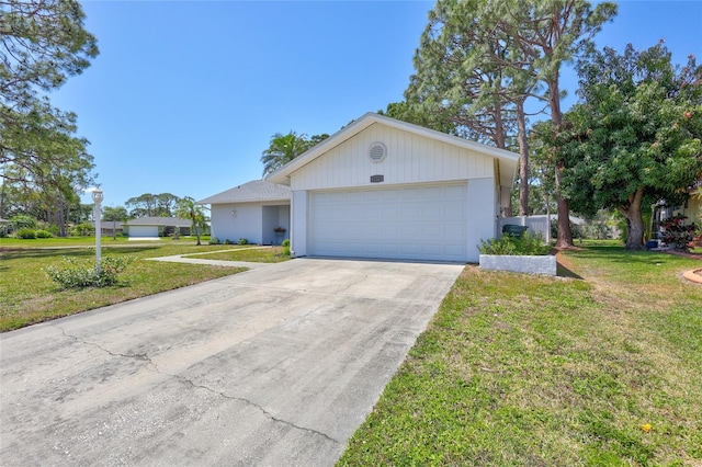 3978 Lemonwood Dr, Sarasota, FL 34232 - ranch-style home with a garage, a front yard, concrete driveway, and stucco siding