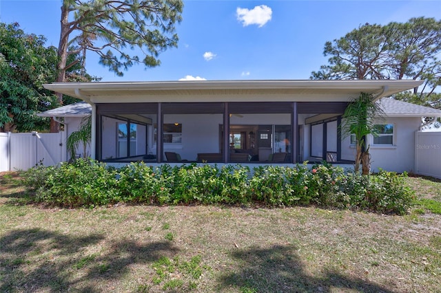 3978 Lemonwood Dr, Sarasota, FL 34232 - rear view of property with a gate, fence, a sunroom, and stucco siding