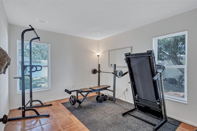 3978 Lemonwood Dr, Sarasota, FL 34232 - workout area with a textured ceiling, baseboards, and tile patterned flooring