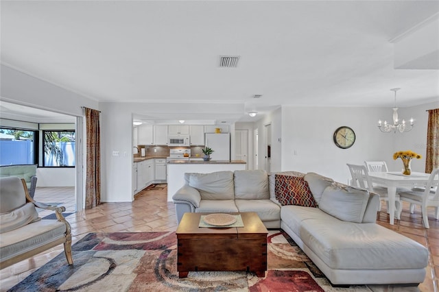 3978 Lemonwood Dr, Sarasota, FL 34232 - living area with ornamental molding, visible vents, and a chandelier