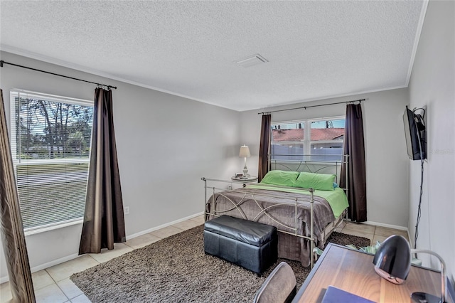 3978 Lemonwood Dr, Sarasota, FL 34232 - bedroom with a textured ceiling, light tile patterned floors, and baseboards