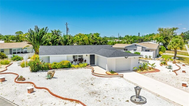 6628 Keystone Dr, Sarasota, FL 34231 - ranch-style home featuring an attached garage, driveway, roof with shingles, and stucco siding