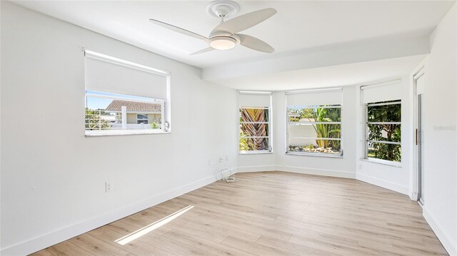 6628 Keystone Dr, Sarasota, FL 34231 - unfurnished room featuring healthy amount of natural light, light wood finished floors, and ceiling fan