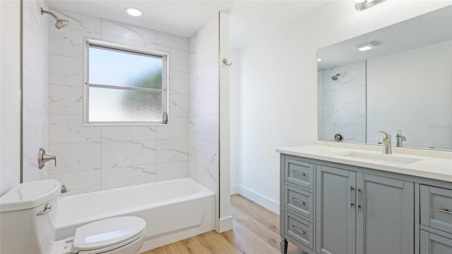 6628 Keystone Dr, Sarasota, FL 34231 - full bath featuring toilet, vanity, wood finished floors, and washtub / shower combination