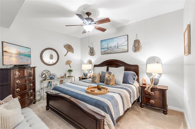 7803 Grand Estuary Trl Unit 102, Bradenton, FL 34212 - bedroom with baseboards, ceiling fan, and light carpet