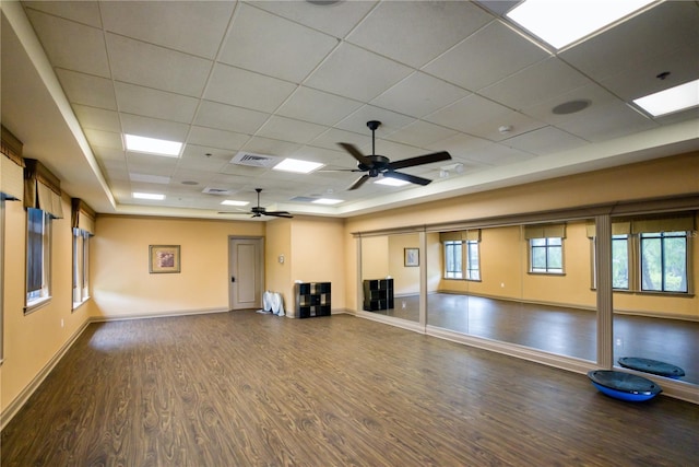 7803 Grand Estuary Trl Unit 102, Bradenton, FL 34212 - unfurnished living room featuring visible vents, baseboards, a ceiling fan, wood finished floors, and a drop ceiling
