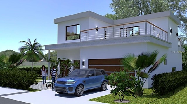 1423 S Shade Ave, Sarasota, FL 34239 - view of front of house featuring a balcony, stucco siding, a garage, and concrete driveway