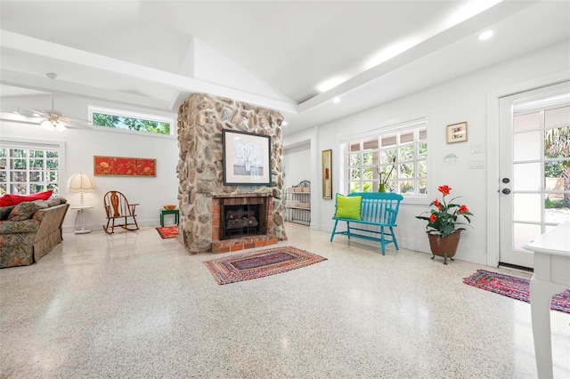 living room featuring speckled floor, ceiling fan, lofted ceiling, and a healthy amount of sunlight