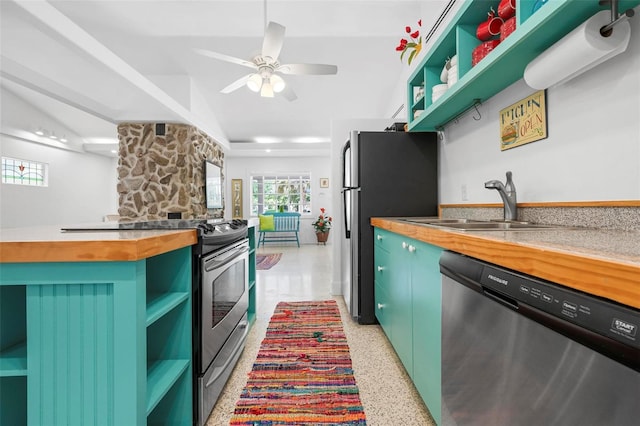 kitchen with stainless steel appliances, open shelves, a ceiling fan, butcher block counters, and green cabinets