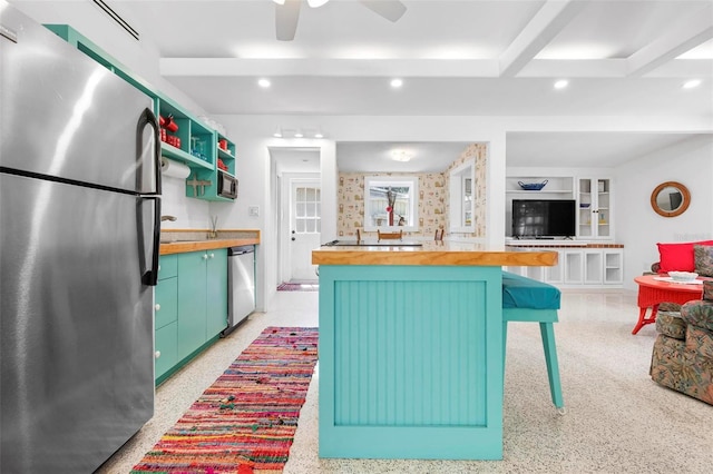 kitchen with stainless steel appliances, a ceiling fan, recessed lighting, and wooden counters