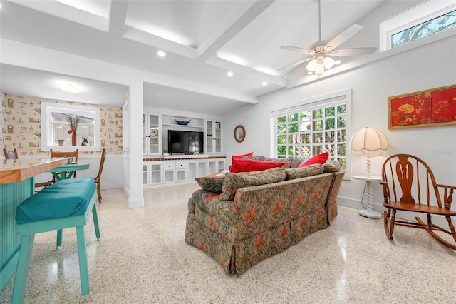living area with speckled floor, baseboards, a wealth of natural light, and recessed lighting