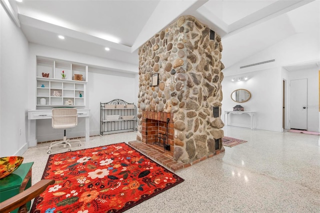 interior space featuring speckled floor, lofted ceiling, a stone fireplace, and recessed lighting