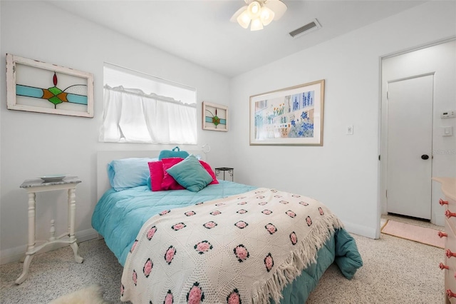 bedroom with speckled floor, visible vents, and baseboards
