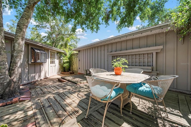 wooden terrace with fence and outdoor dining space