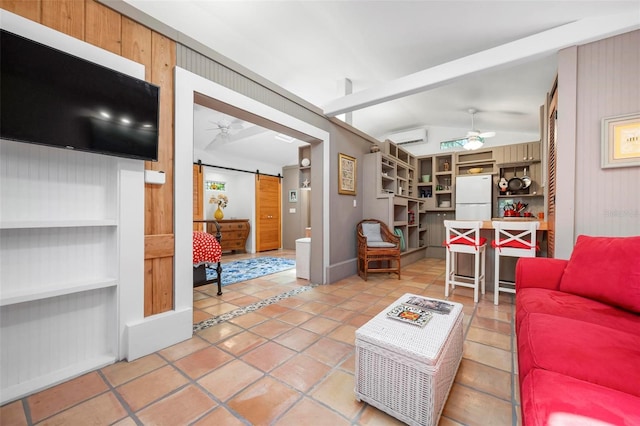 living room featuring a barn door, lofted ceiling, a ceiling fan, a wall unit AC, and light tile patterned floors