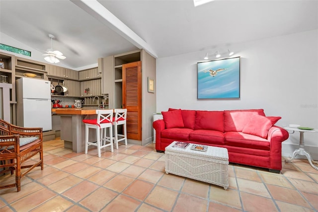 living area featuring ceiling fan and lofted ceiling