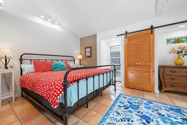 tiled bedroom with a barn door and lofted ceiling