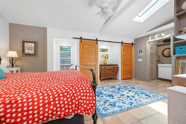 tiled bedroom featuring a barn door, vaulted ceiling, and ceiling fan