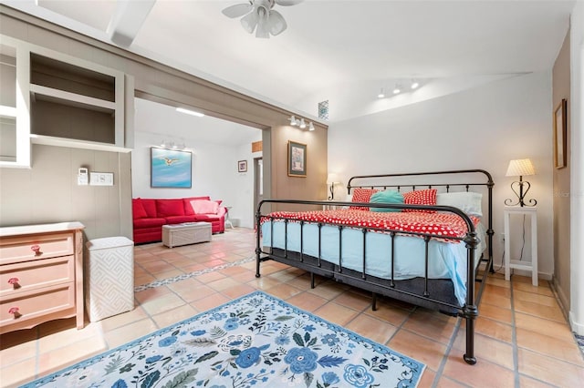 bedroom with lofted ceiling and tile patterned floors