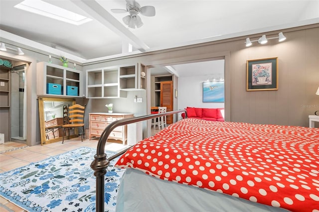 tiled bedroom with vaulted ceiling with skylight