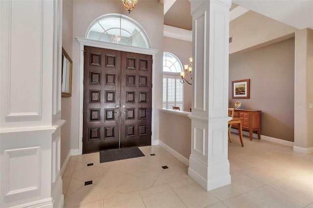 3738 Eagle Hammock Dr, Sarasota, FL 34240 - entryway with decorative columns, baseboards, and light tile patterned flooring