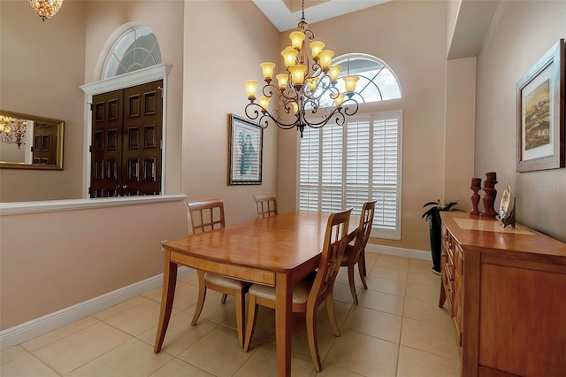3738 Eagle Hammock Dr, Sarasota, FL 34240 - dining area featuring baseboards, a high ceiling, a chandelier, and light tile patterned floors