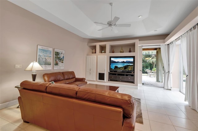 3738 Eagle Hammock Dr, Sarasota, FL 34240 - living area featuring baseboards, a ceiling fan, a tray ceiling, and light tile patterned floors