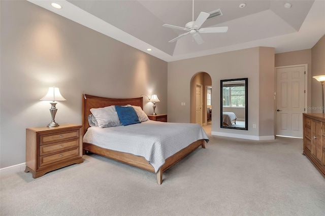 3738 Eagle Hammock Dr, Sarasota, FL 34240 - bedroom featuring light carpet, a tray ceiling, and arched walkways