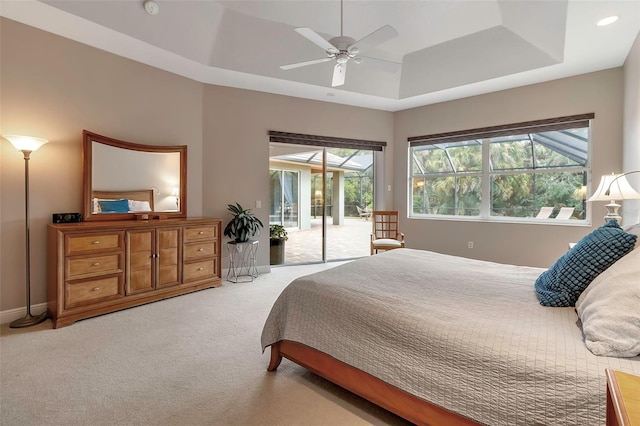 3738 Eagle Hammock Dr, Sarasota, FL 34240 - carpeted bedroom with multiple windows, a ceiling fan, a tray ceiling, and access to exterior